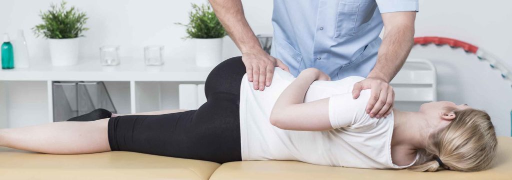 Chiropractor consulting with a patient before performing a safe chiropractic treatment."