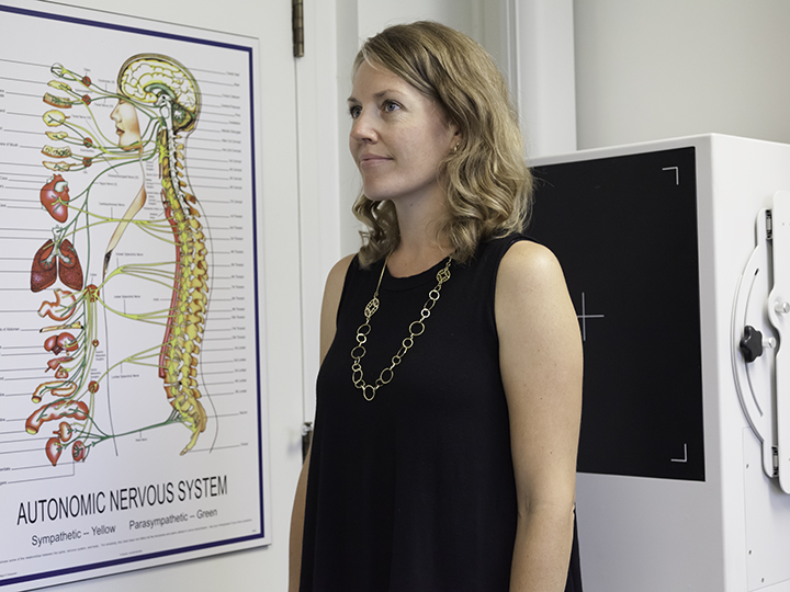 Chiropractor conducting a spinal assessment on a patient to identify adjustment areas
