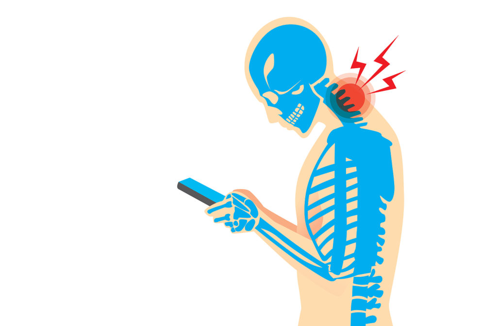 Person experiencing neck pain while using a laptop, demonstrating symptoms of tech neck.